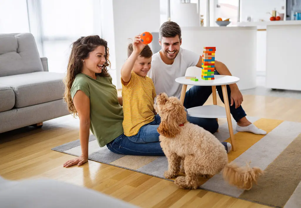 family with a kid and pet in home