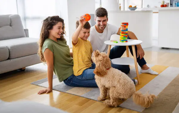 family with a kid and pet in home